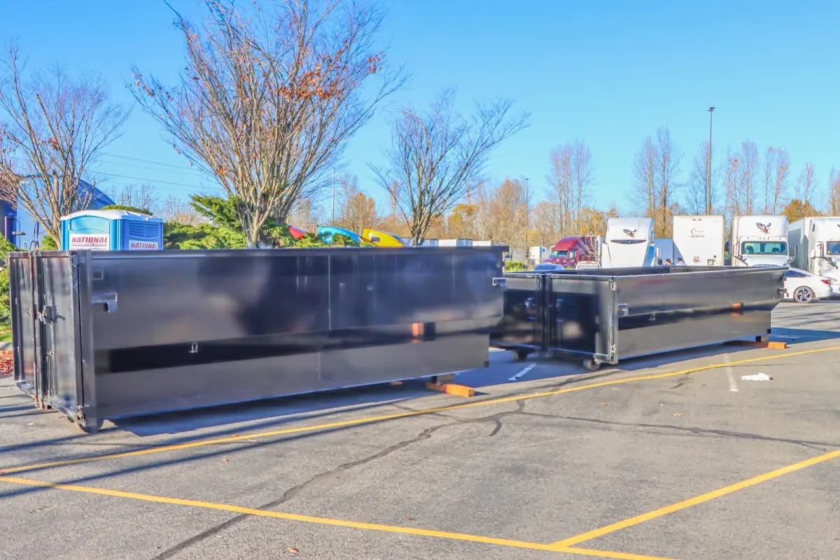 Professional dumpster rental service with roll-off container on residential driveway in Mishawaka